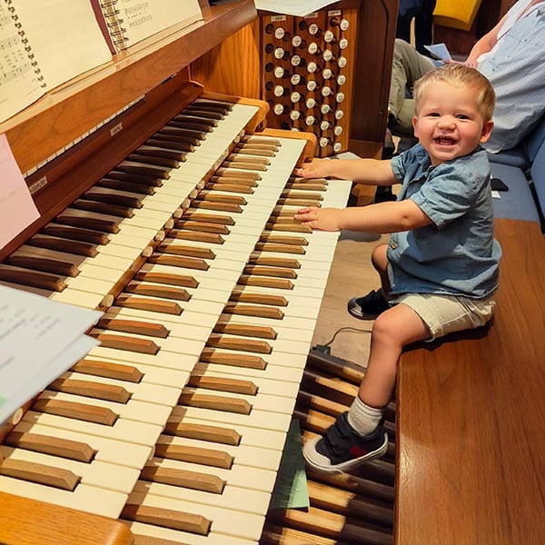 Our young ones love sitting with the organist at Peace With Christ Lutheran Church in Fort Collins, CO