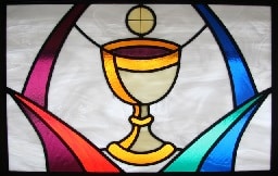 Stained glass window depicting chalice and communion host