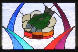 Stained glass window showing loaves and fish