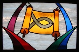 Stained glass window with Old Testament scroll and fish symbol