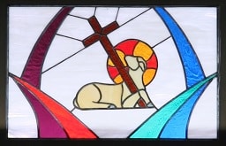 Stained glass window depicting the Lamb of God with cross