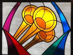 Stained glass window with trumpets of praise