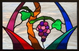 Stained glass window depicting vine, branch, and grapes